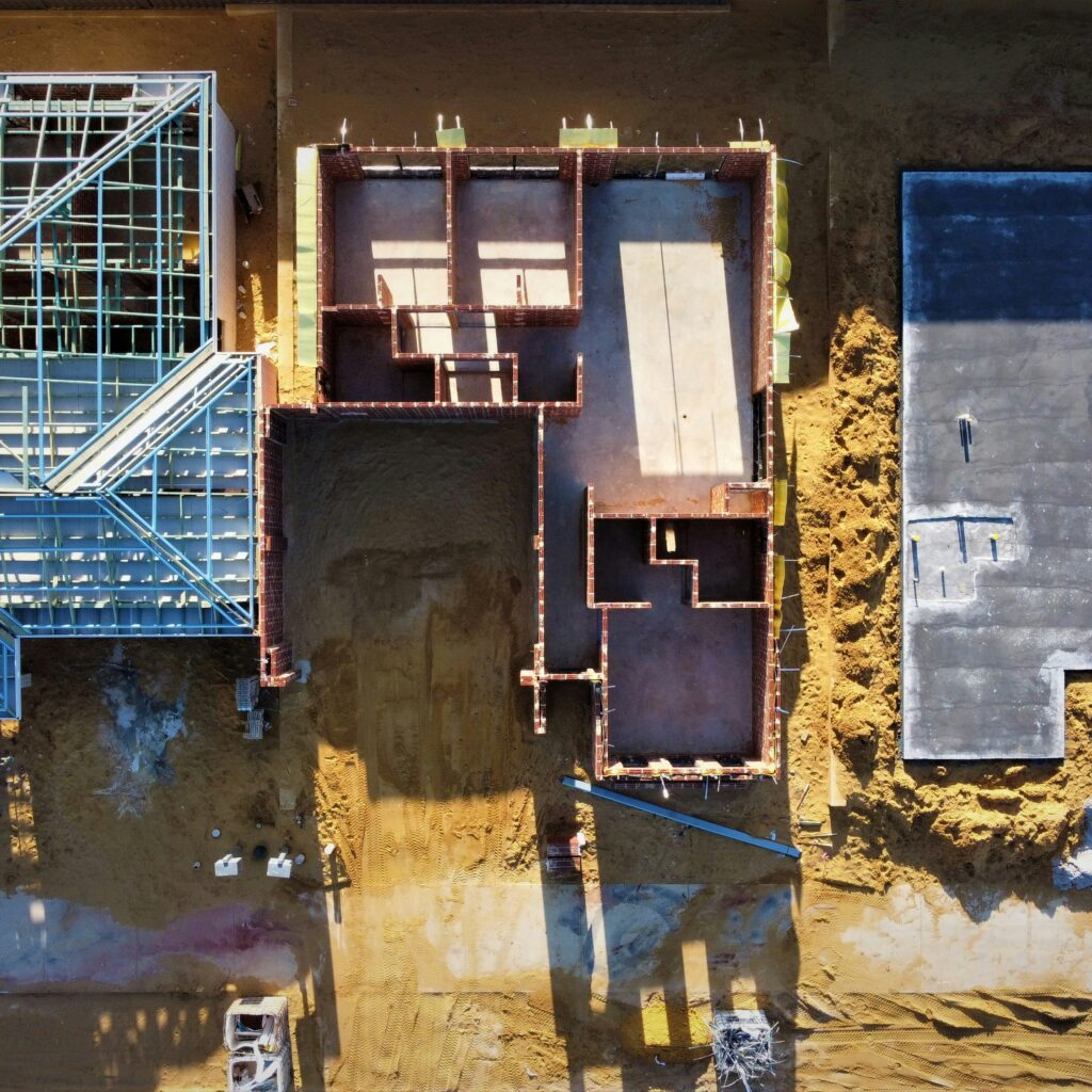 Aerial view of three building plots at different construction stages, representing data platform architecture choices