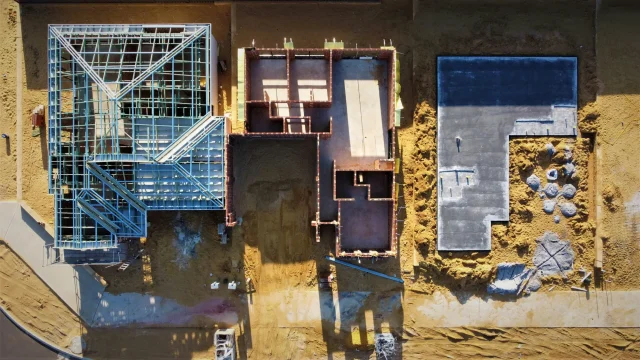 Aerial view of three building plots at different construction stages, representing data platform architecture choices