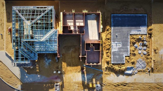Aerial view of three building plots at different construction stages, representing data platform architecture choices